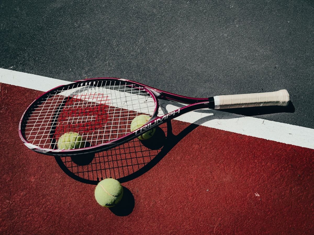 Tennis racket and balls on court